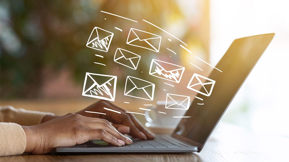 business owner using a laptop to send email configured with SPF, DKIM, & DMARC setup.