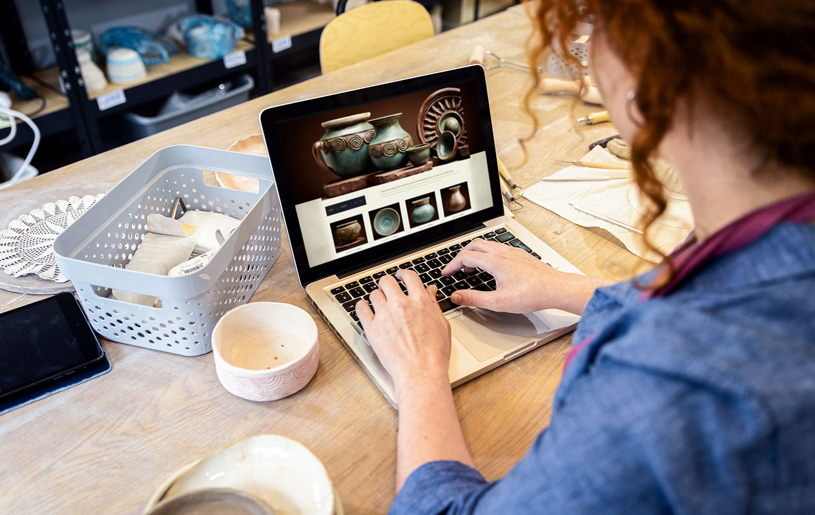 Female business owner on laptop viewing new subscription based website.