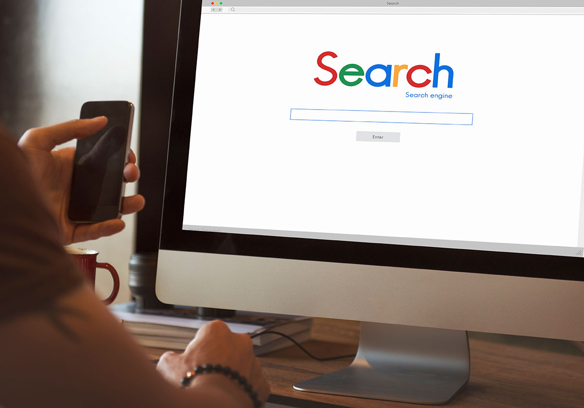 Person searching on Google to find their new website created by Graphicten in Ocala.