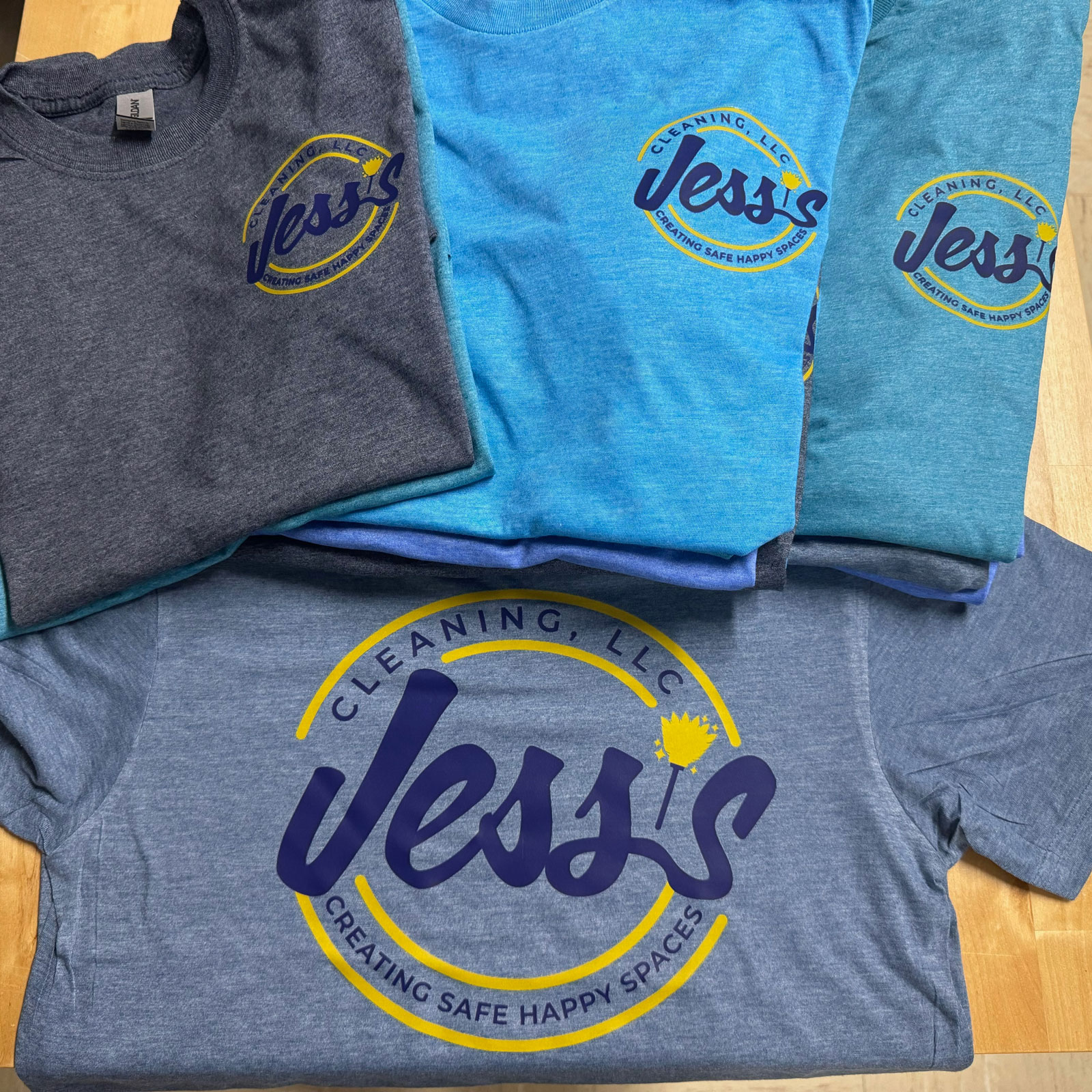 Image of multiple work shirts for Jess's Cleaning in Ocala printed with Direct to Film.