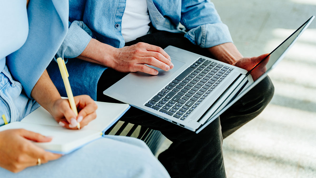 Two people collaborating on writing new content for their website.