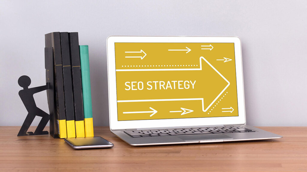 Image of a laptop on a desk with SEO Strategy on the screen.
