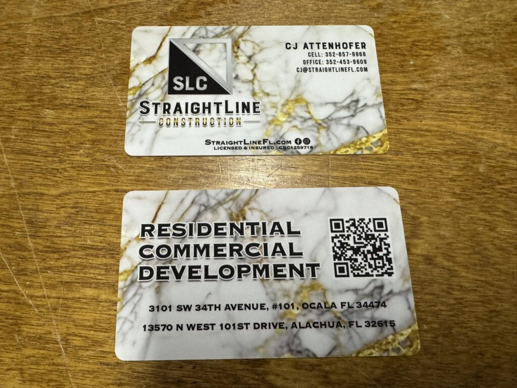 Business cards for a construction company in Ocala and Gainesville.